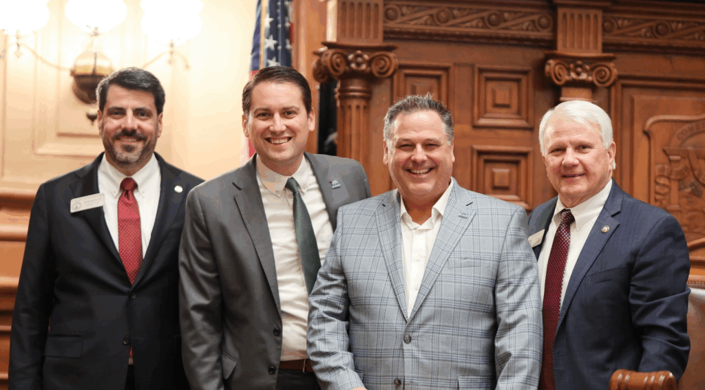 Michael Coker at the Georgia State Capitol with state lawmakers representing the City of Mulberry